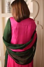 Person wrapped in a pink and green  suit with matching dupatta