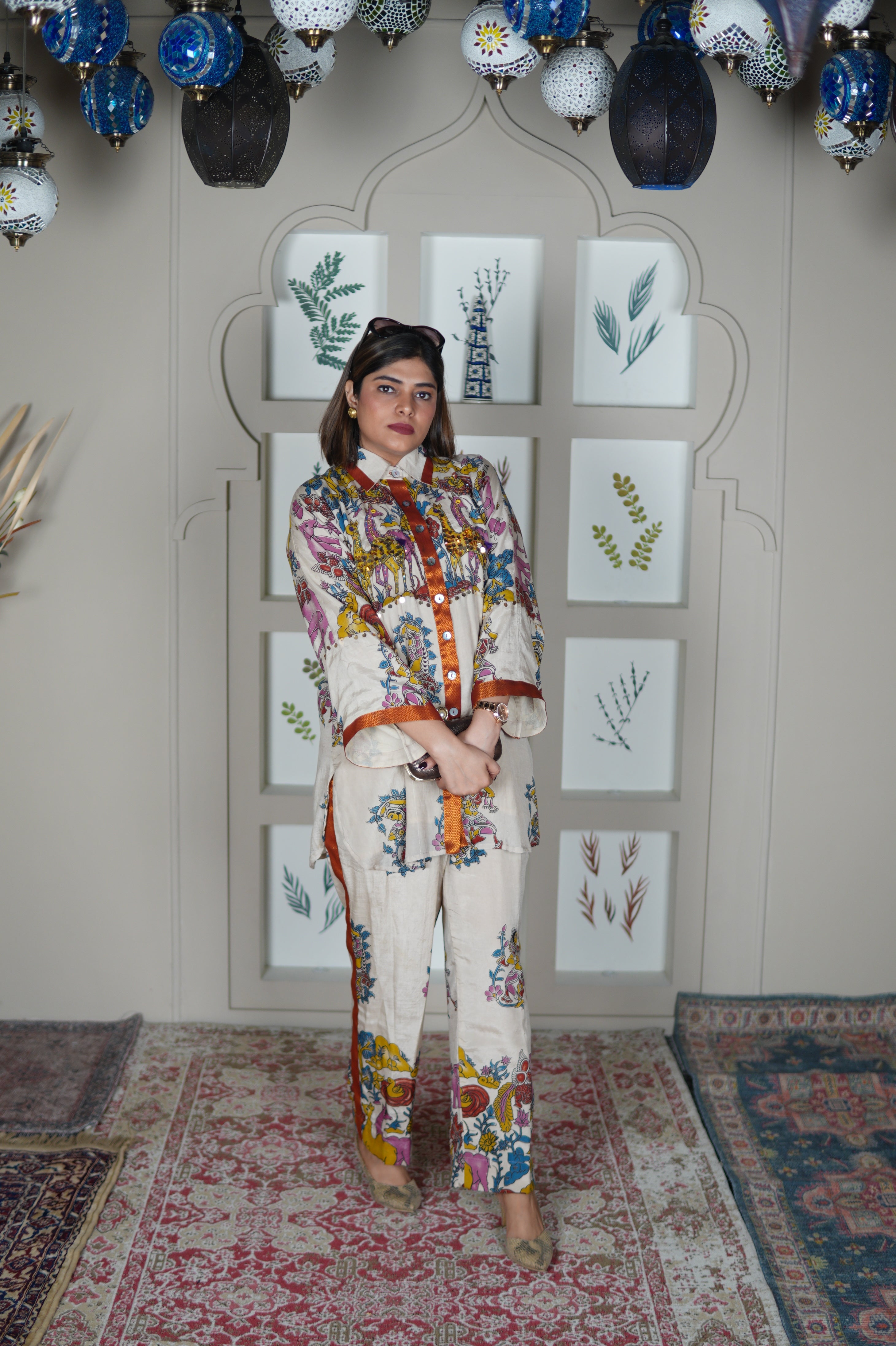 Woman in a colorful outfit standing .